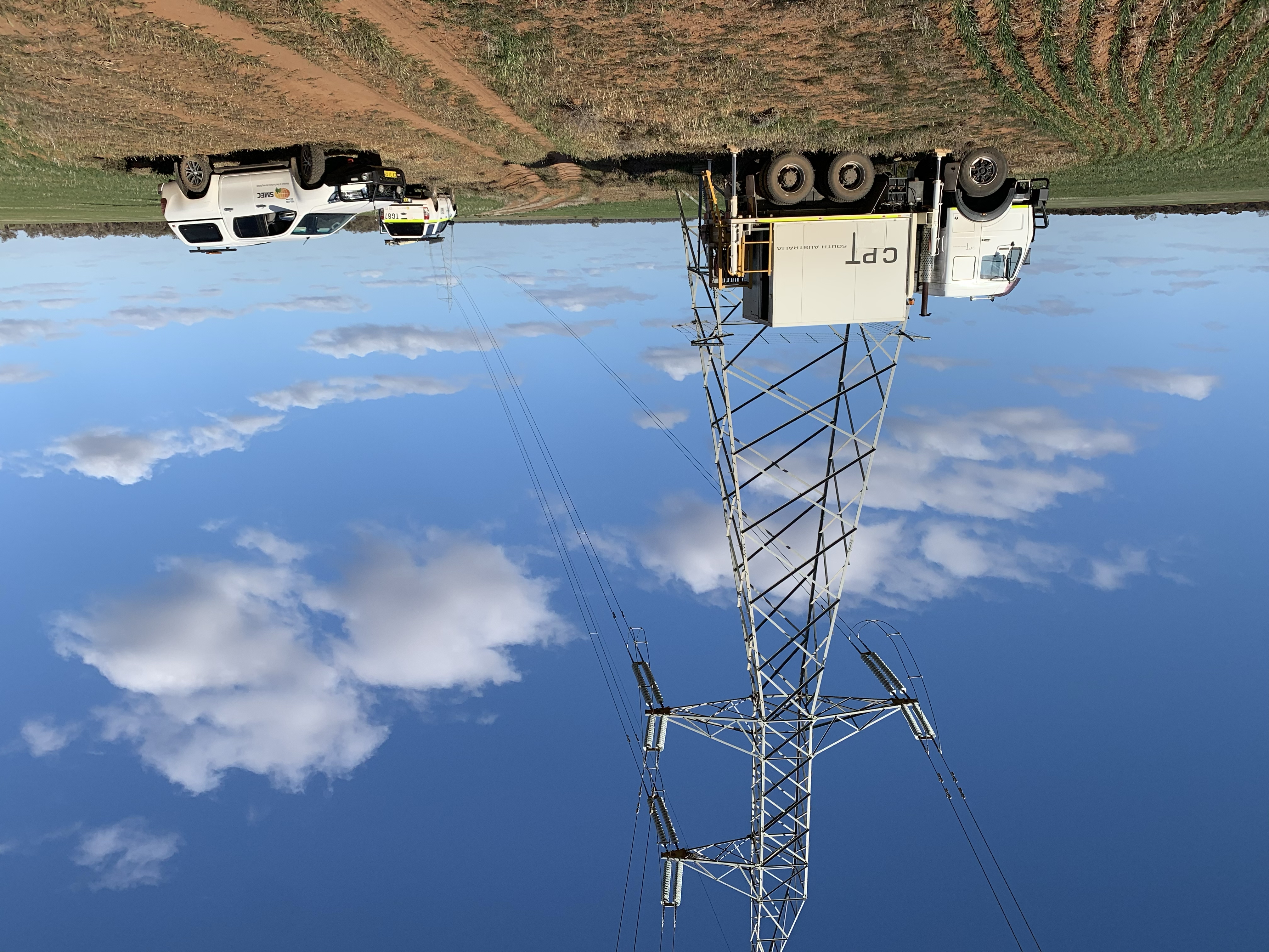 CPT South Australia truck operating beside a high-voltage transmission tower